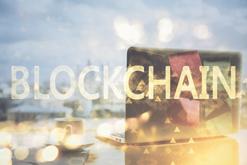 Double exposure of blockchain theme hologram and table with computer background. Concept of bitcoin crypto currency.