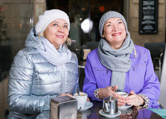 Two happy senior women at terrace cafe