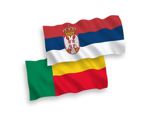 National vector fabric wave flags of Benin and Serbia isolated on white background. 1 to 2 proportion.
