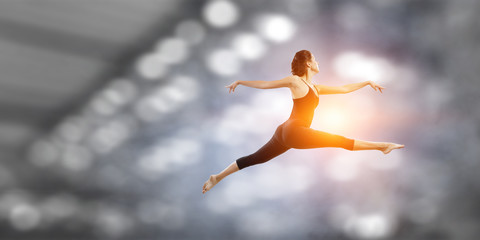 Fototapeta premium Gymnast girl in jump Mixed media