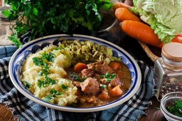 Traditional irish stew served with potatoes and cabbage