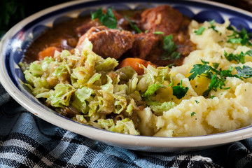 Traditional irish stew served with potatoes and cabbage