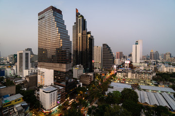 Naklejka premium Twilight over Bangkok Silom business district with modern hotels and office tower in Thailand capital city in Southeast Asia