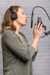 Radio worker, works in the studio, broadcasts recording. Blogging and podcasts. Vertical shot.