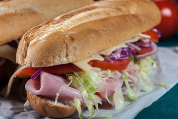 Submarine sandwiches with ham, cheese and vegetables