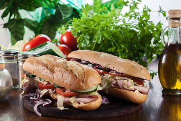 Submarine sandwiches with ham, cheese and vegetables