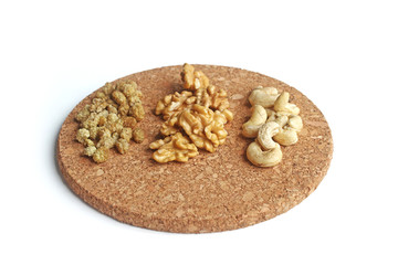 Almonds, walnuts and hazelnuts in wooden bowls on wooden background