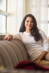 Portrait of a Hispanic woman at home.