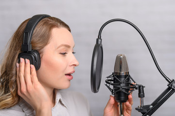 Girl works on the radio or the news. Reads the news in the studio. Radio station and broadcast....