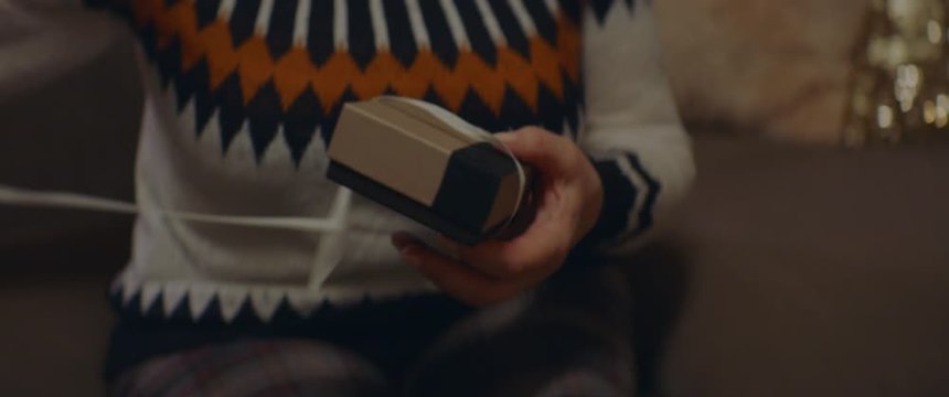 CU elderly retired woman receives a gift with with jewelry from her husband on Christmas Eve. Shot on ARRI Alexa Mini with Cooke 2x Anamorphic lenses. 4K UHD RAW Graded footage