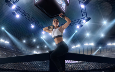 Fototapeta na wymiar MMA female fighters on professional ring.