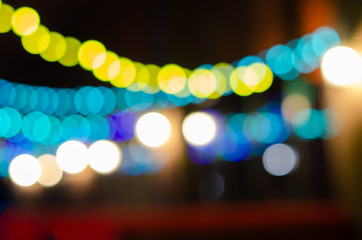 Abstract background with colored Garland light bokeh in dark. Bokeh abstract for background.