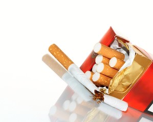 pack of cigarettes laying on a glossy reflective surface stock photo