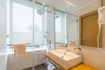 Interior of a luxury hotel bathroom with glass shower cabin