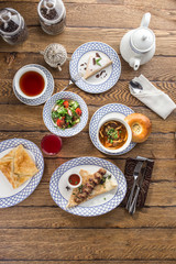Gourmet meals assorted set shish kebab shurpa khachapuri on wooden table Buffet at restaurant