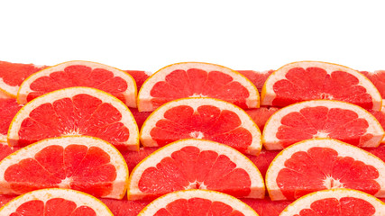 Grapefruit red juicy slices background. top view.