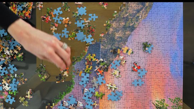 Woman sorts puzzle pieces by color and design