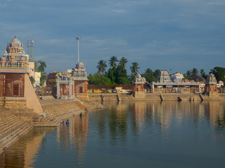 Fototapeta na wymiar People of Hindu religion bathing in religious Haridranathi water tank in Theppakulam, South India