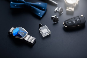 Luxury fashion men's cufflinks. Accessories for tuxedo, butterfly, tie, handkerchief, style watch and smartphone, car key isolated on the black background.