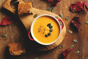 Soup pumpkin, sweet potato, carrot   with pumpkins seeds and thyme leaves