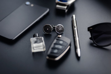 Luxury fashion men's cufflinks. Accessories for tuxedo, butterfly, tie, handkerchief, style watch and smartphone, car key isolated on the black background. - Powered by Adobe