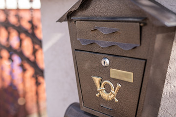 A beautiful mailbox hangs waiting for newspapers, parcels and letters from friends.