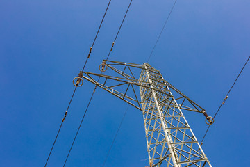 Electricity transmission power lines at sunset. High voltage tower