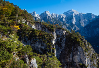Sunny colorful autumn alpine scene. Peaceful rocky mountain view from hiking path near Almsee lake, Upper Austria.