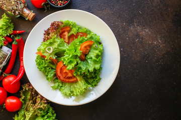 Healthy salad, leaves mix salad (mix micro greens, cucumber, tomato, chili pepper, other ingredients). food background. copy space
