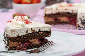 Chocolate cake with whipped cream icing on plate