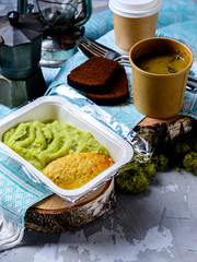 cutlet and mashed potatoes in a container