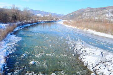 Winter landscape with the river in frosty day