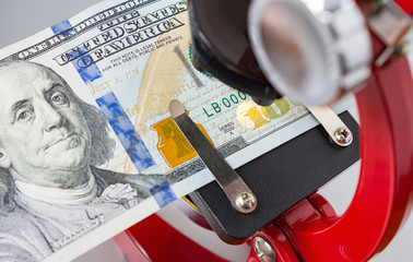 100 US dollar bill under the microscope, testing counterfeit money. Anti-counterfeit technology....