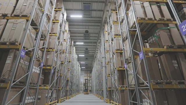 Long rows of bright modern warehouse. Large warehouse with boxes on shelves