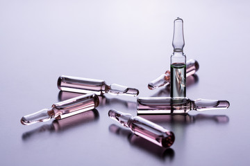 Medical ampoules close up. Many ampoules. Glass ampoules on the table. Scattered ampoules with...