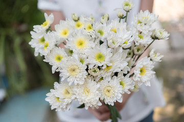 Woman holding white flowers