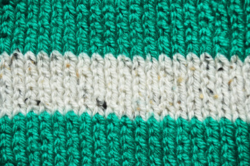 Handmade knitted fabric green and white wool background texture