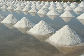 Rows of salt piles in salt-farm, Thailand.