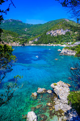 Paleokastritsa - Paradise coastline scenery with crystal clear azure water in Bay at white beach -...