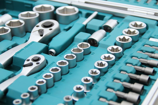 a fully stocked ratchet box with various bits and nuts