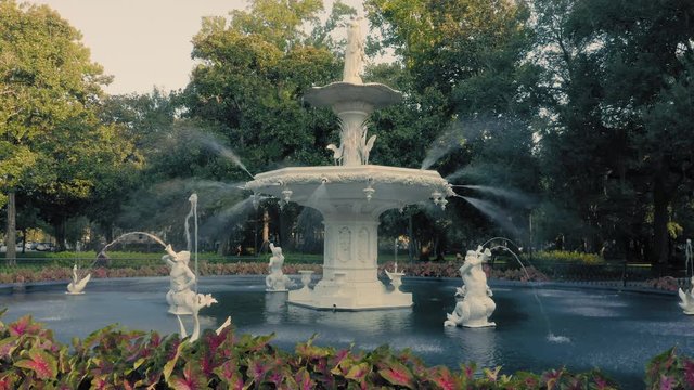 Aerial:  Fountain & oak trees with rays of light shining through. Forsyth Park. Savannah, Georgia, USA.