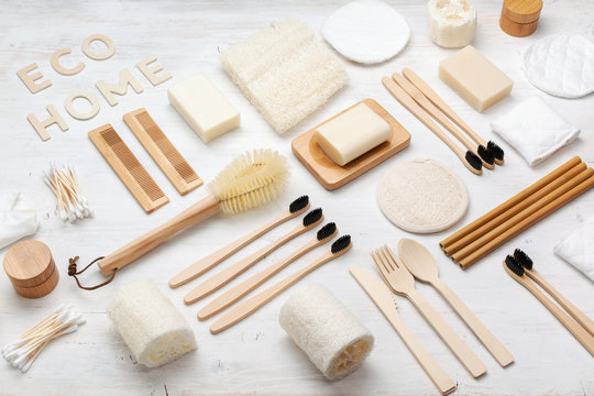 Eco living. Creative flatlay with natural biodegradable accessories. Bamboo toothbrushes, handmade soap shampoo bars, cotton buds pads, hygiene products luffa on white, top view