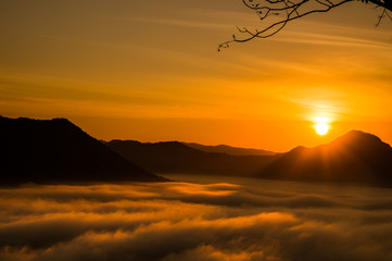 Stunning amazed natural landscape of sun rising above mountain and sea of mist in the fresh morning...