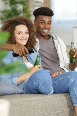 Fototapeta premium picture of sweet couple posing holding beer bottle