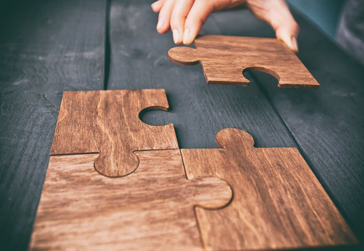 The Woman Hand Connecting Puzzles To Each Other