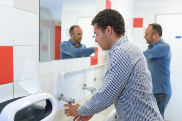 a man is washing hands