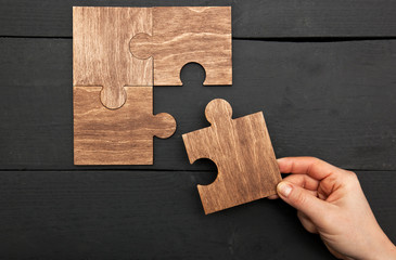 The woman hand connecting puzzles to each other