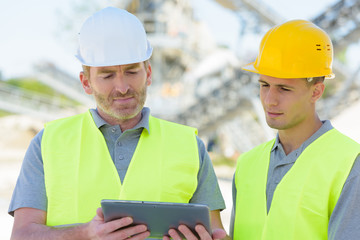 modern building workers checking laptop