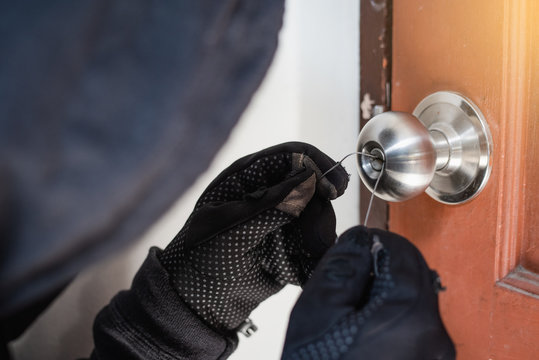 Burglar breaking the door.