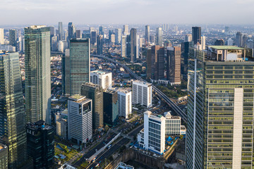 Fototapeta na wymiar Aerial view of the modern Jakarta central business district along the Sudirman avenue with many corporate offices towers in Indonesia capital city